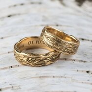 Handcrafted 14k yellow gold wedding rings with wood-grain texture