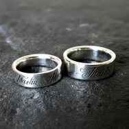 Handcrafted sterling silver wedding rings with laser-engraved names