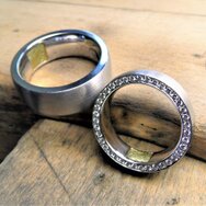 Handcrafted 14k white gold wedding rings with fingerprint gold inlay and diamond setting