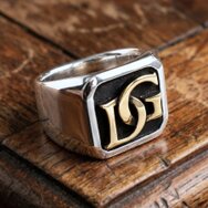Handcrafted two-tone signet ring in sterling silver and gold with personalized raised initials