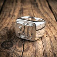Handcrafted sterling silver signet ring with raised letter M and polished finish