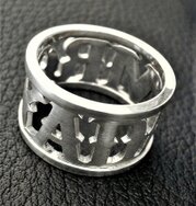 Handcrafted sterling silver band ring with cut-out lettering and openwork design