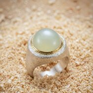 Handcrafted silver and gold statement ring with large round moonstone cabochon and textured finish