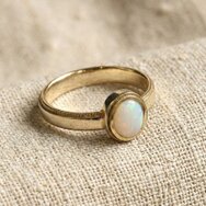 Handcrafted yellow gold ring with oval opal and delicate milgrain setting