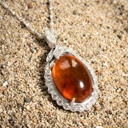 Handcrafted white gold pendant with clear amber and diamond accents