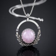Handcrafted silver pendant with soft pink rose quartz in an artistic organic setting