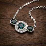 Handcrafted silver pendant with three oval green tourmalines and diamonds